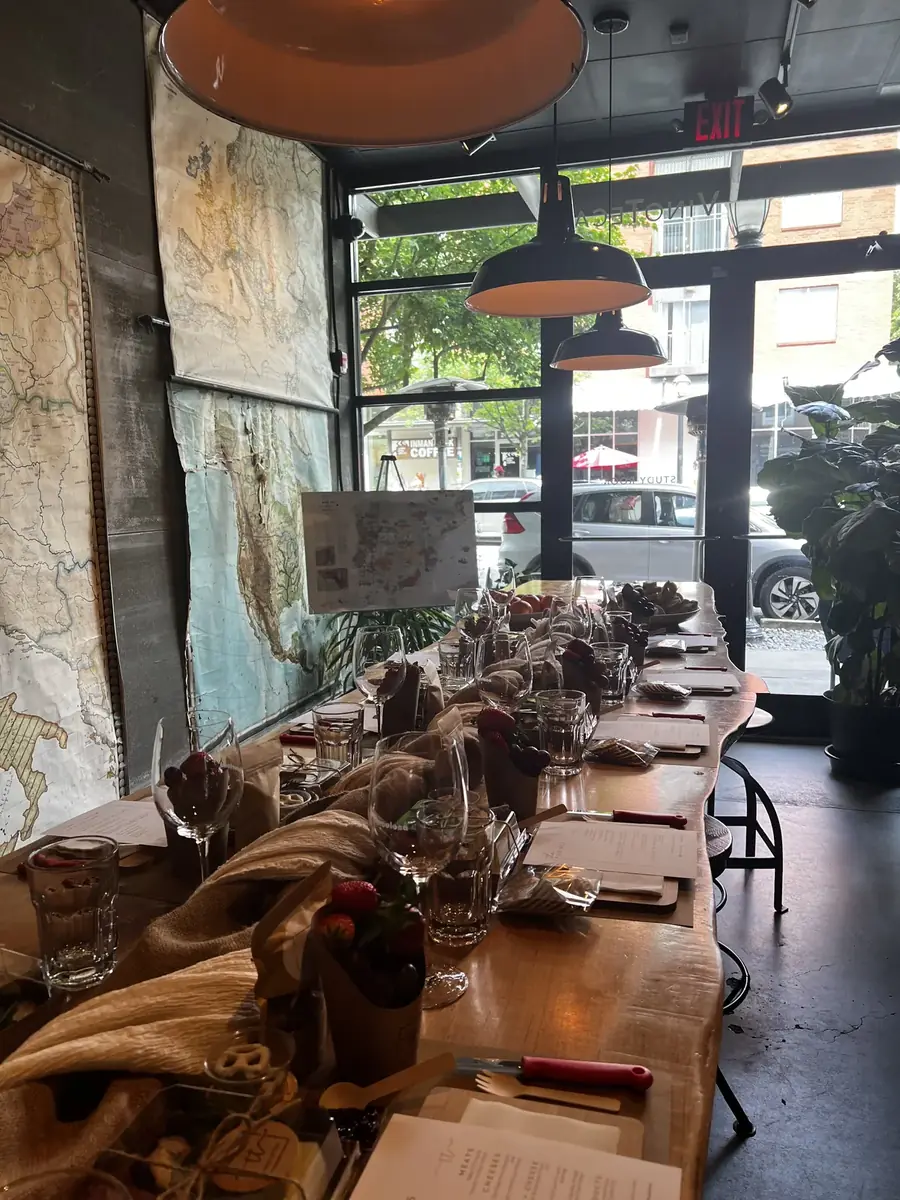 Workshop table laid with boards, greenery and pouring vessels before guests arrive